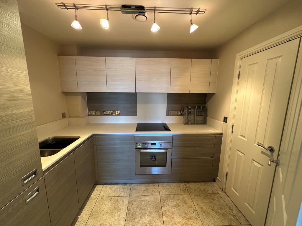 Lot: 62 - TWO-BEDROOM PURPOSE-BUILT FLAT WITH UNDERGROUND PARKING - Kitchen with built in appliances